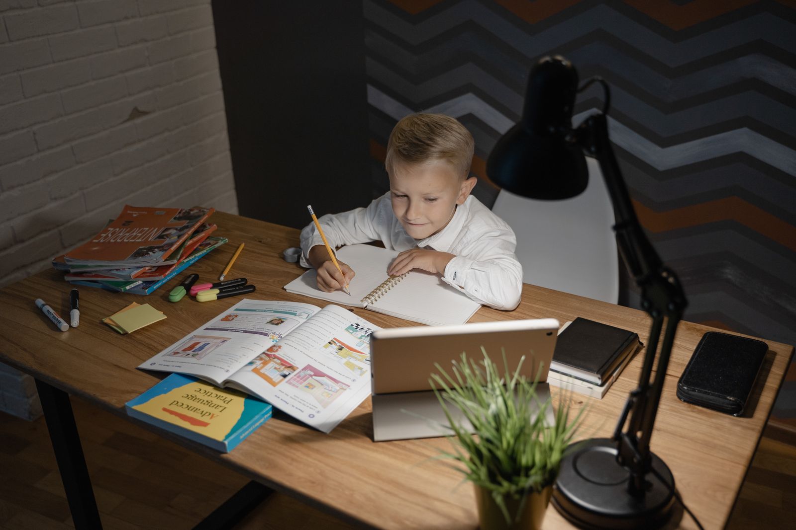 A child reading at a kitchen table in warm afternoon light