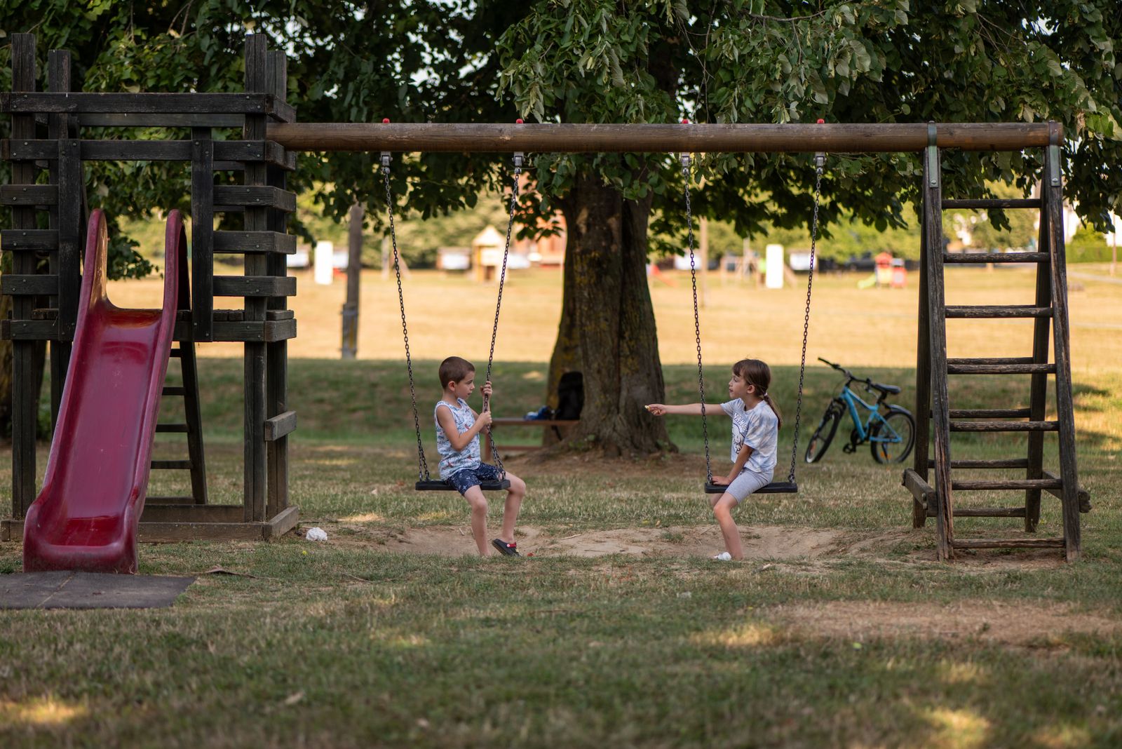 Children playing outdoors in a park on a sunny afternoon