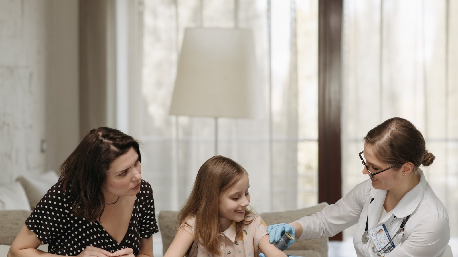 A doctor talking with a parent and child