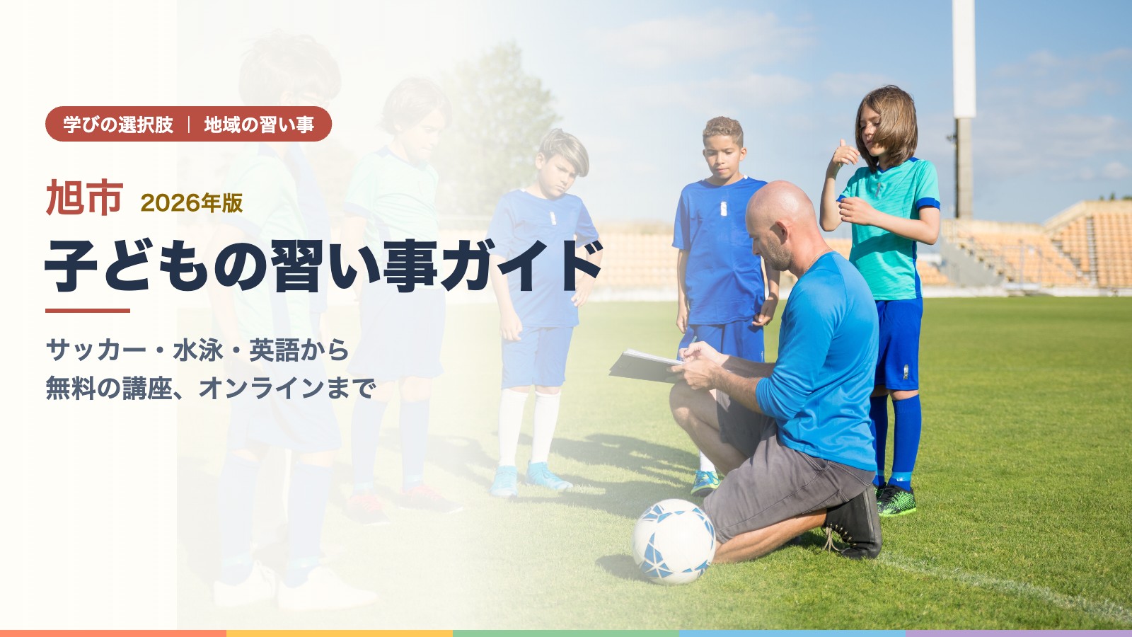 芝生のグラウンドでコーチの指導を受けながらサッカーを練習する子どもたち