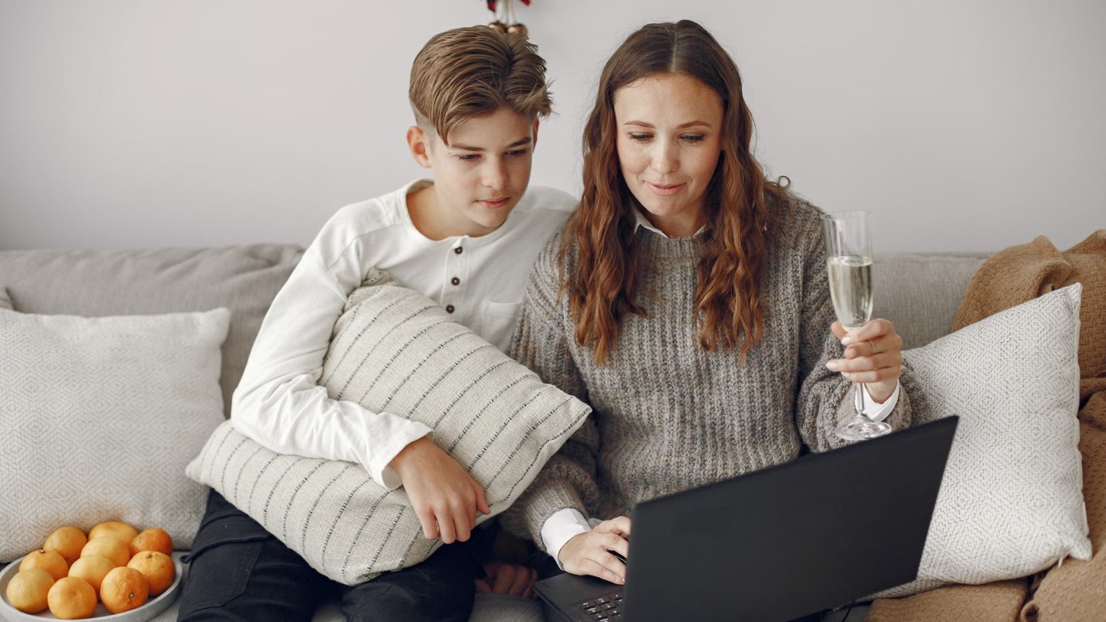 A parent and teenager looking at a laptop together