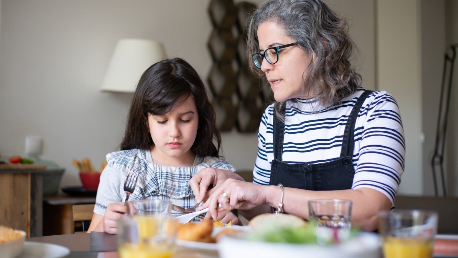 A parent and child talking at a table