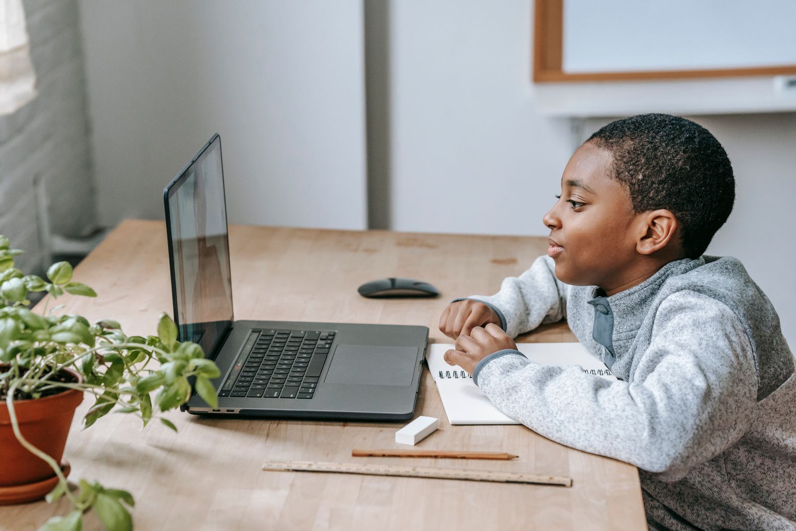 A child joining a small group video lesson at a kitchen table