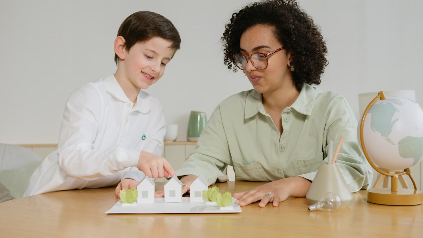 A boy doing a science experiment with a teacher