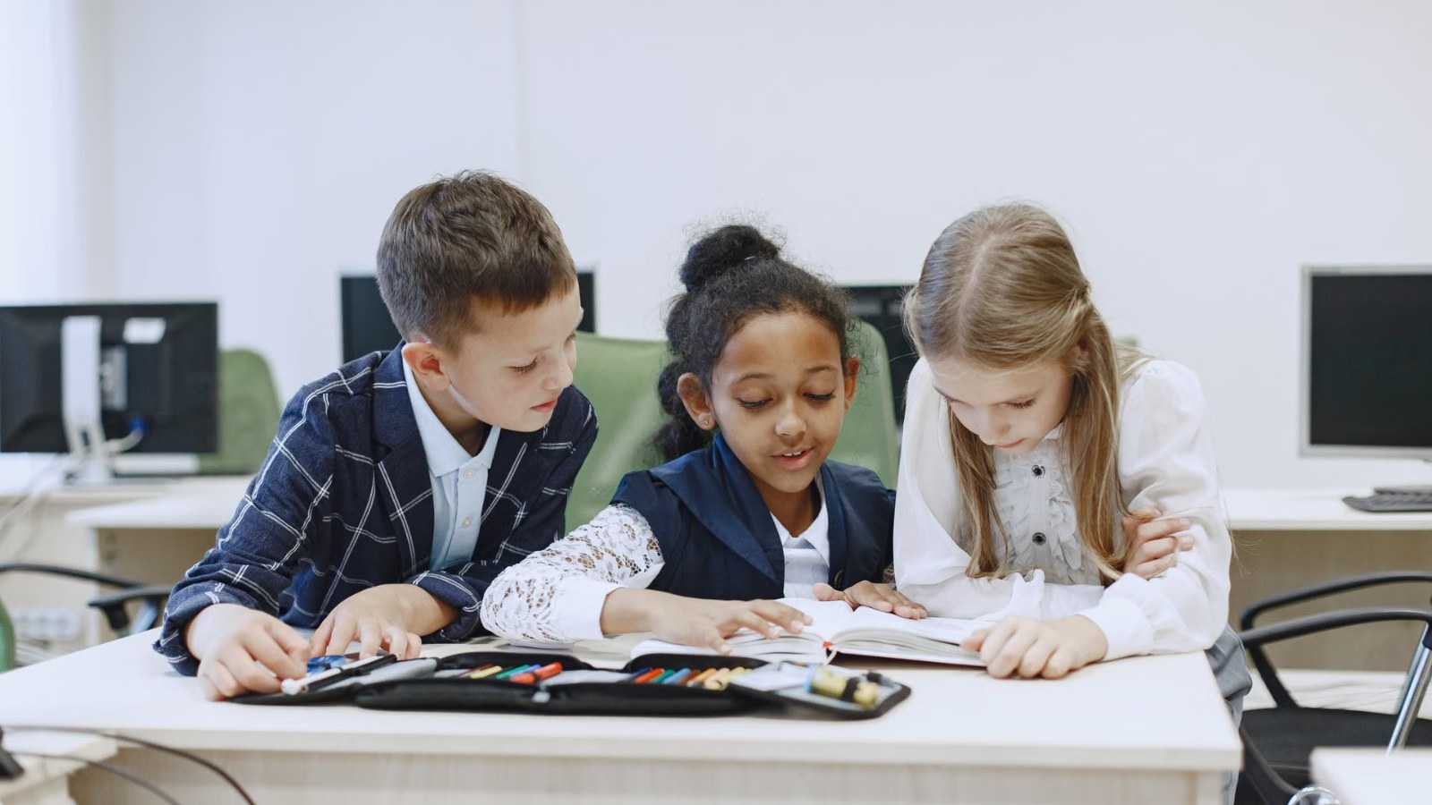 Children working at computers in a classroom