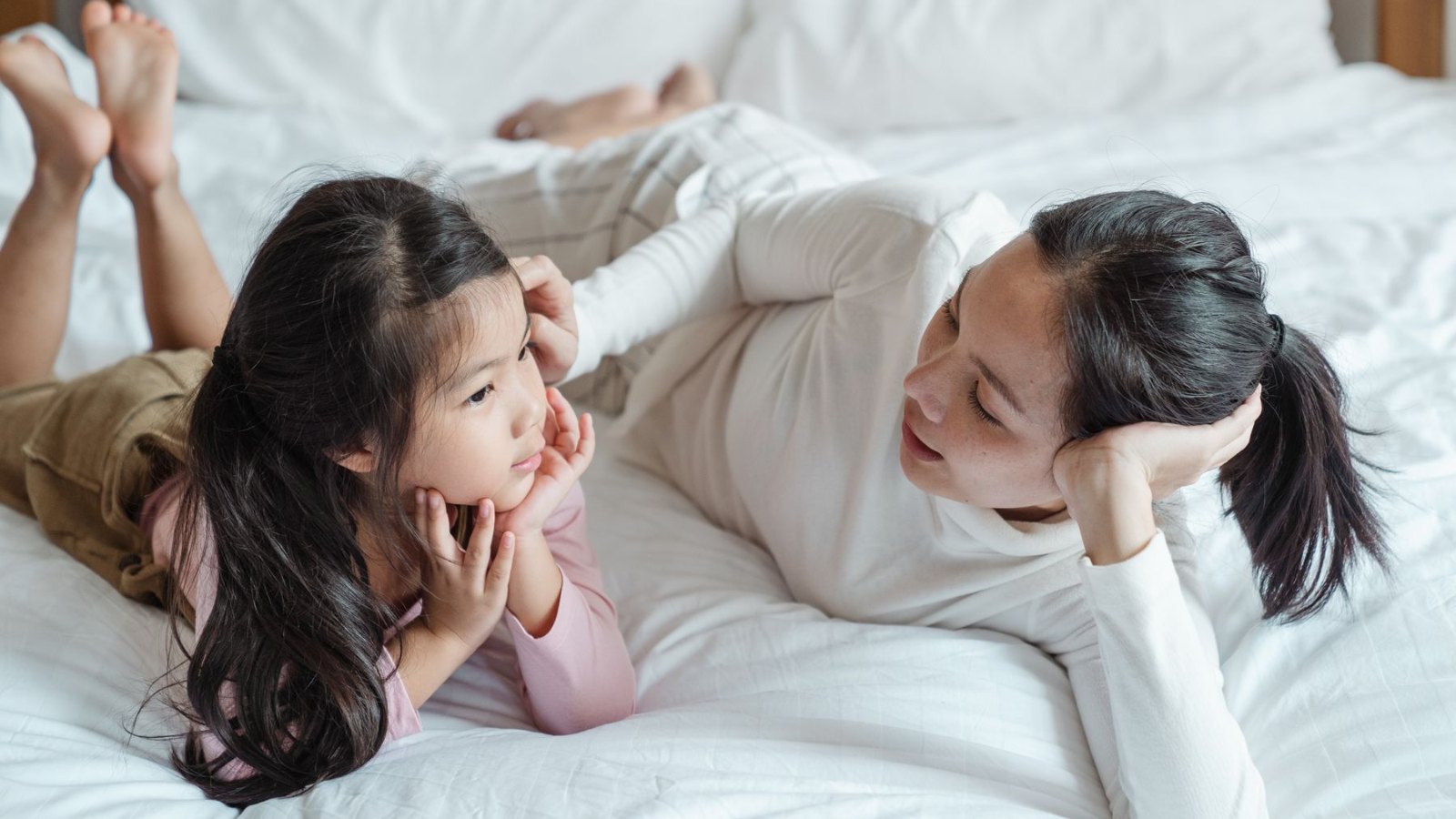 家のテーブルで向かい合って話す親子
