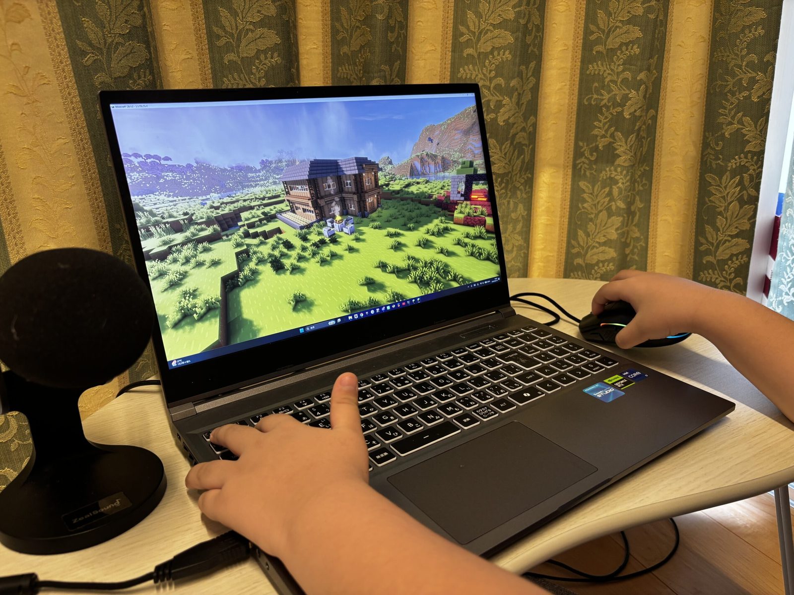 自宅のノートパソコンでマインクラフトの建築を進める小学生の手元