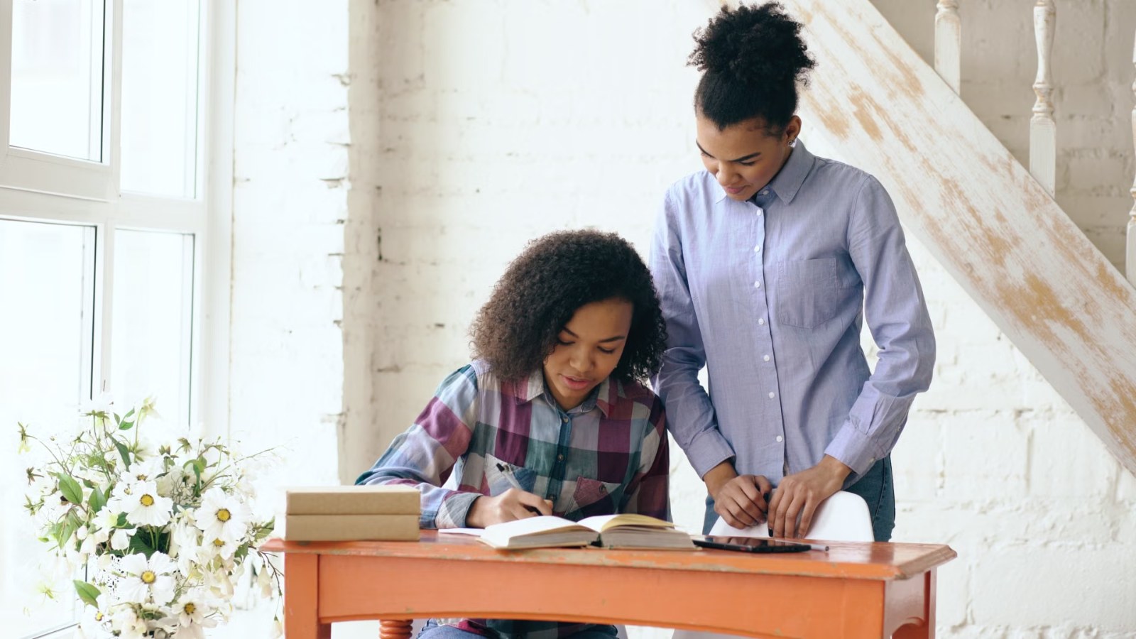 A parent and child at a desk together