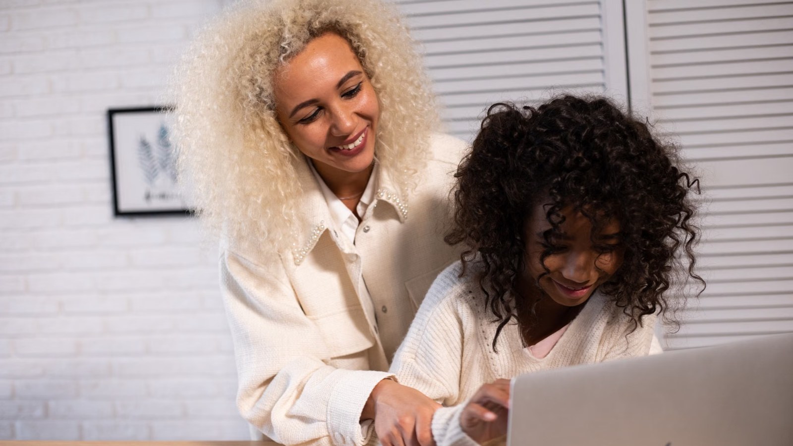 A parent and child using a laptop together