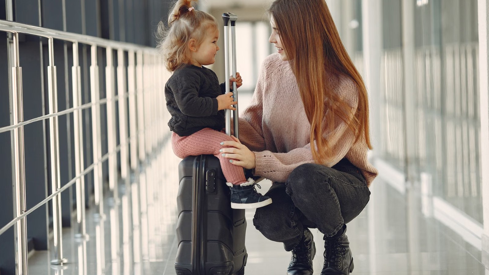 A parent talking with a child at an airport