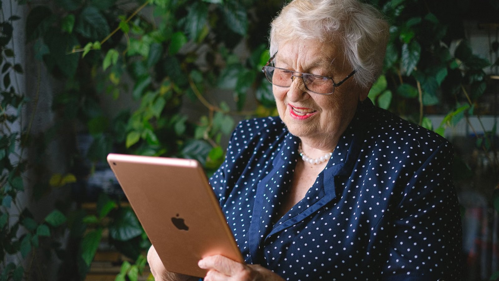 A grandmother on a video call with a tablet, smiling