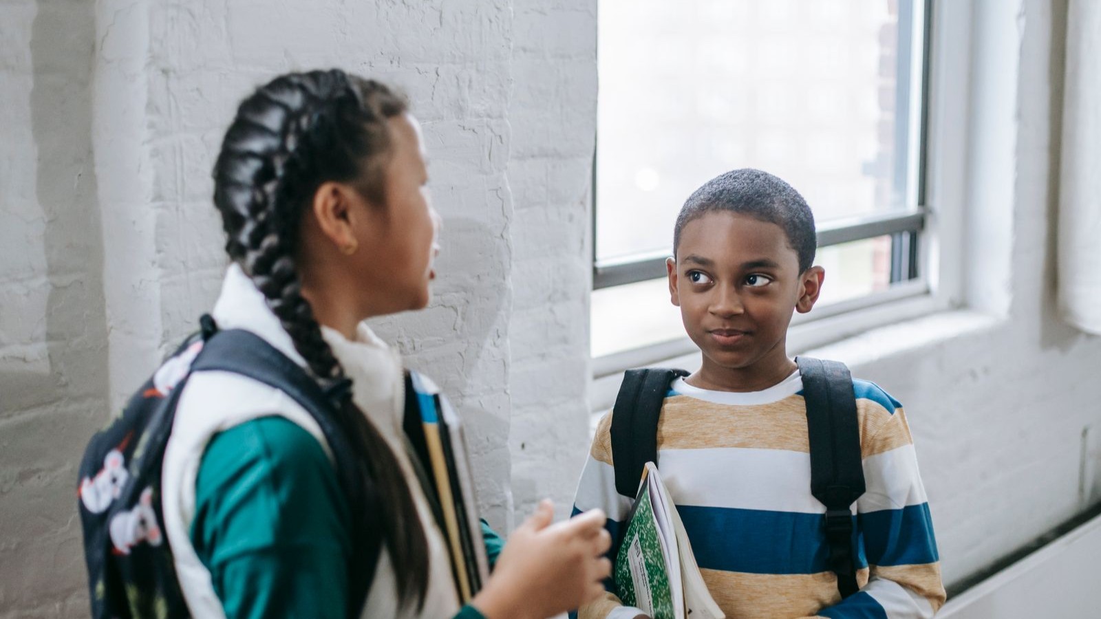 Two children talking to each other outdoors