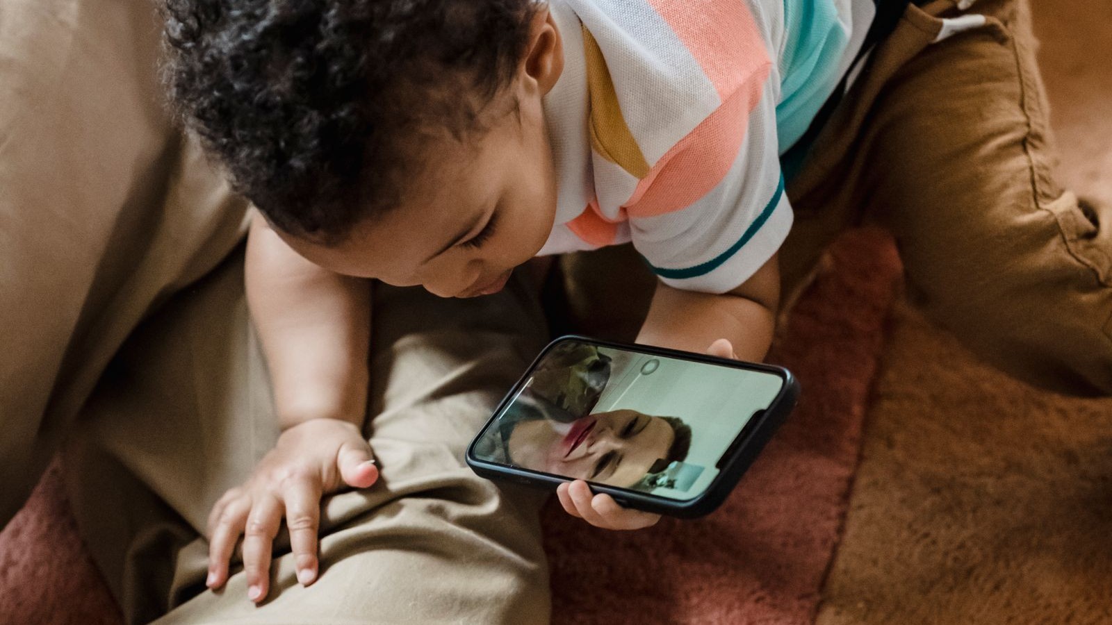 A child talking to a grandparent on a video call on a tablet at home