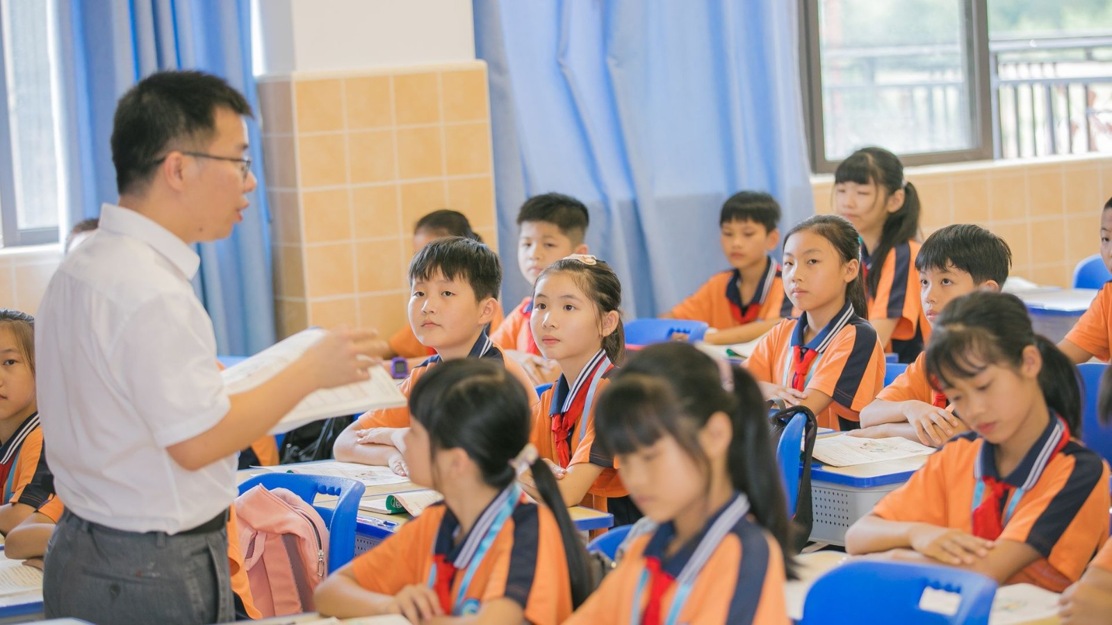 教室で先生の授業を聞く子どもたち