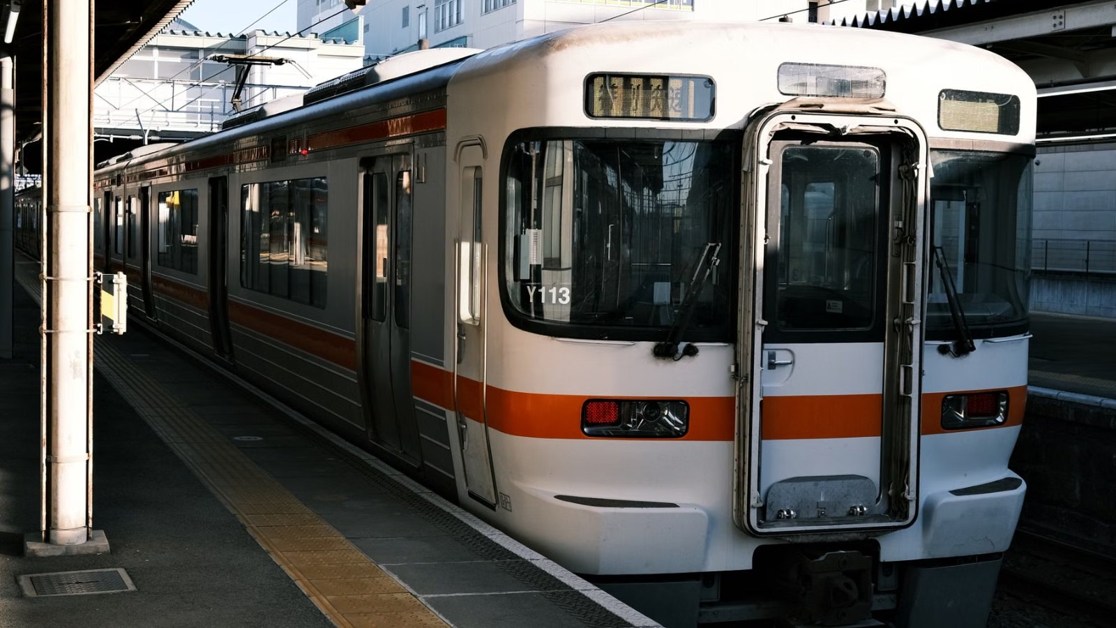 昼の駅に停まる電車