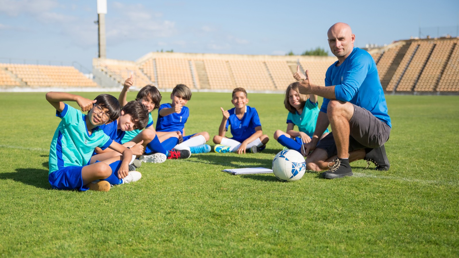 コーチと一緒にサッカーの練習をする子どもたち